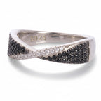 Silver ring with black and white gemstones on a white background