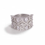 Silver ring with diamond-like stones on a light gray background