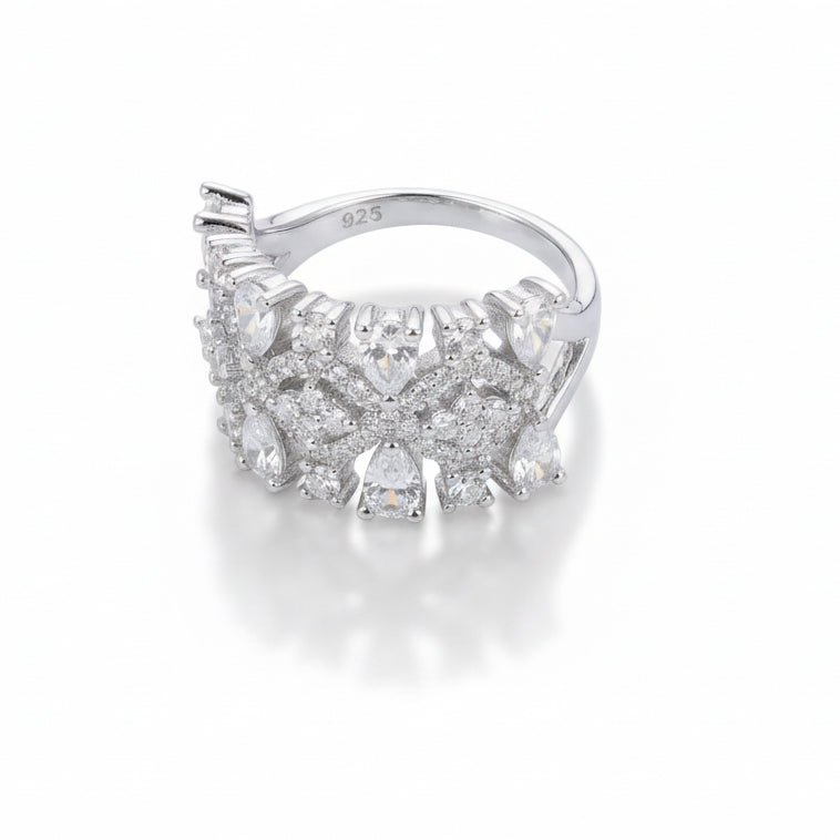 Silver ring with gemstones on a light gray background